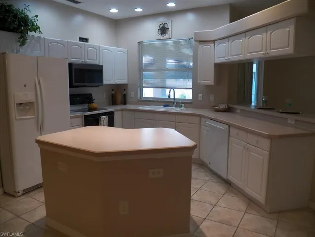Kitchen featuring a window looking out to the lanai over the sink