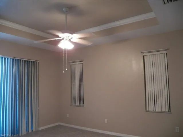 Master bedroom featuring tray ceiling and crown molding