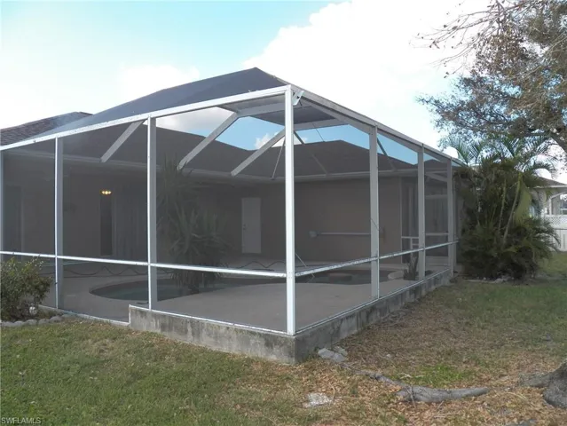 View of home's exterior featuring a patio, a lanai, and backyard