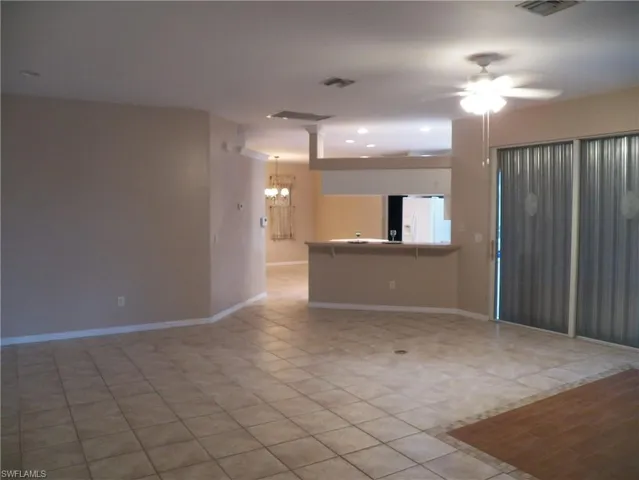 The living room with breakfast bar and shelf above