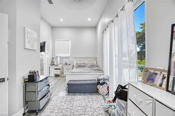 Bedroom with light wood-type flooring and recessed lighting
