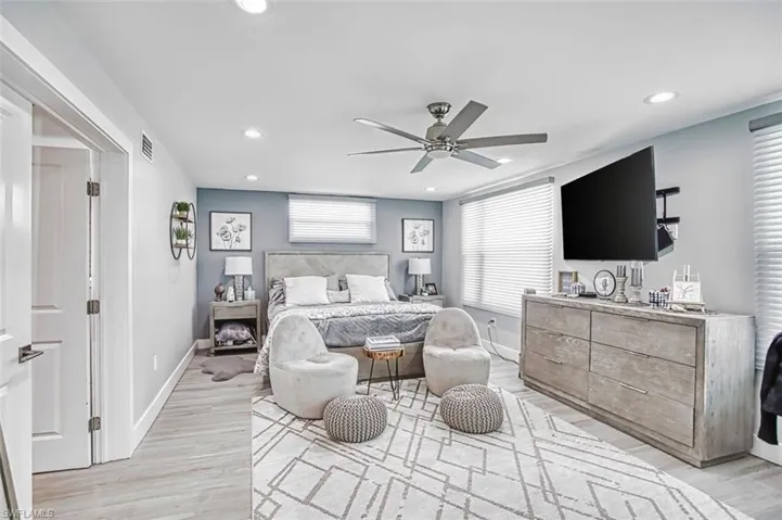 Bedroom with ceiling fan, light wood-style floors, and recessed lighting