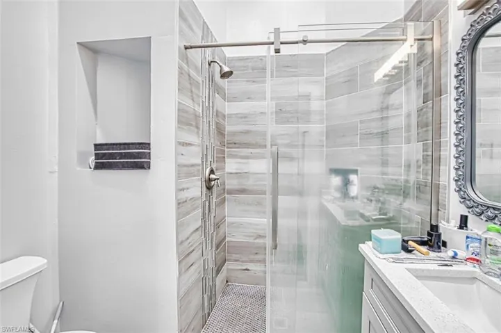 Bathroom featuring vanity and a shower stall
