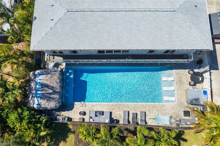 View of subject property featuring a pool area