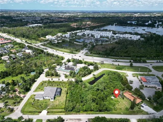 Aerial view of property and surrounding area featuring a nearby body of water