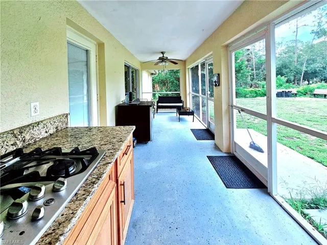 Sunroom featuring a ceiling fan