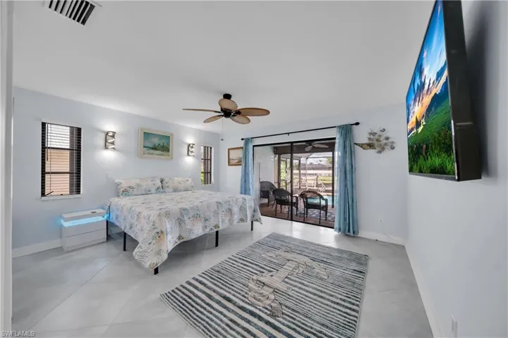 Bedroom with access to exterior and ceiling fan