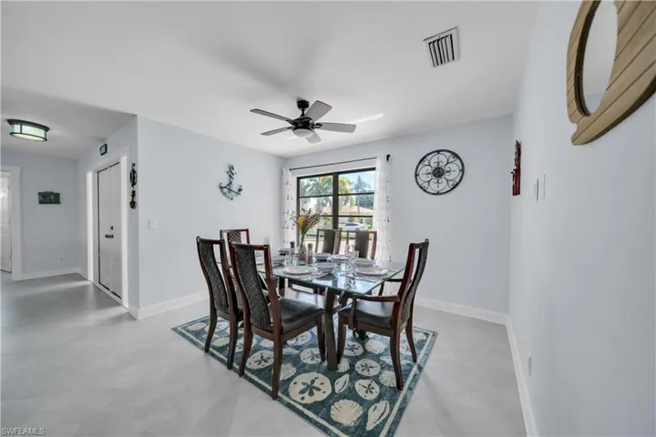 Dining space featuring ceiling fan and light tile patterned floors