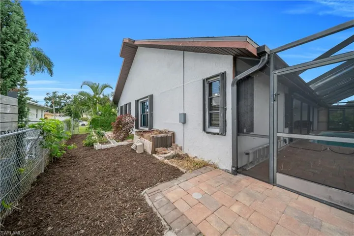 View of home's exterior with a lanai, a patio area, stucco siding, and a sunroom