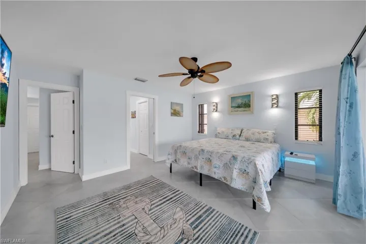 Bedroom featuring a ceiling fan and baseboards