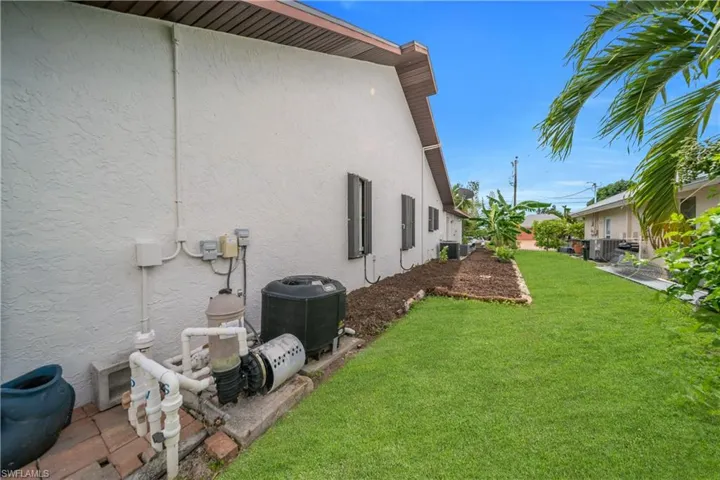 View of home's exterior featuring a yard and stucco siding