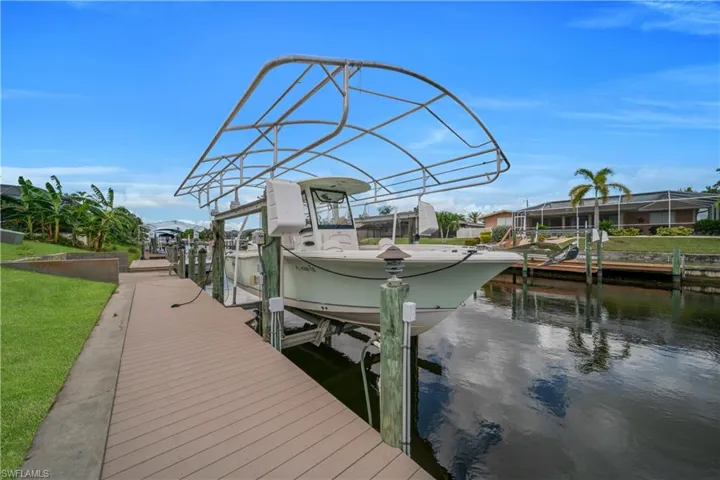 Dock with boat lift and a water view