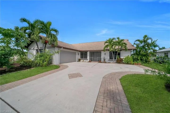 Single story home with driveway, stucco siding, a garage, and a shingled roof