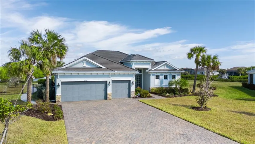 View of front facade with a garage and a front lawn