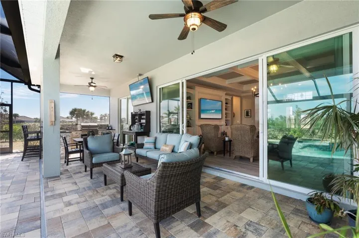 Expansive under truss lanai with summer kitchen, grill, and outdoor hangout area