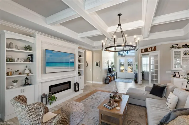 Living room featuring beam ceiling, french doors, and light wood-type flooring