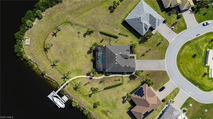 Birds eye view of property with a water view