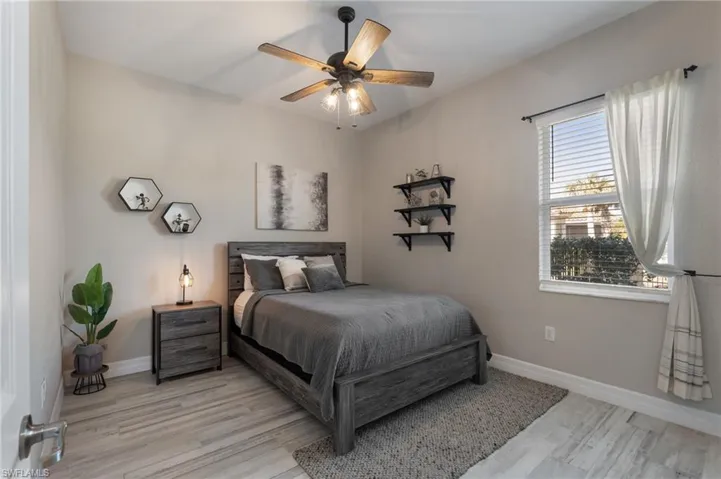 Bedroom with ceiling fan and light hardwood / wood-style floors
