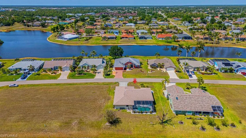 Aerial perspective of suburban area featuring a nearby body of water