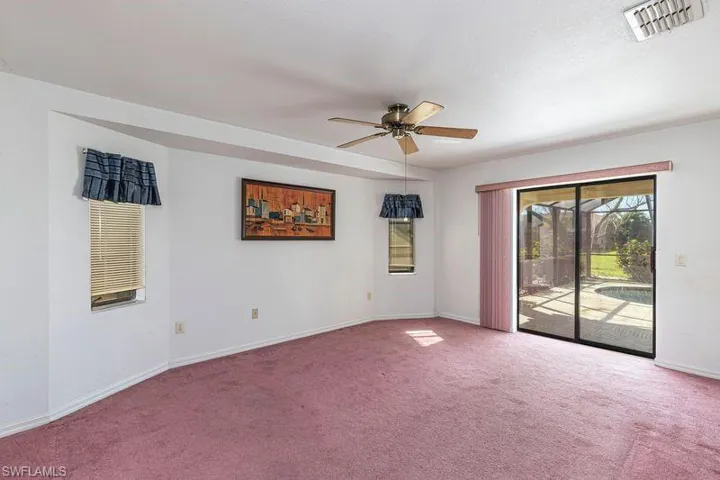 Empty room with carpet floors and ceiling fan