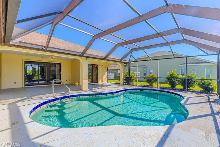 Swimming pool with a sunroom, a patio, a ceiling fan, and a lanai
