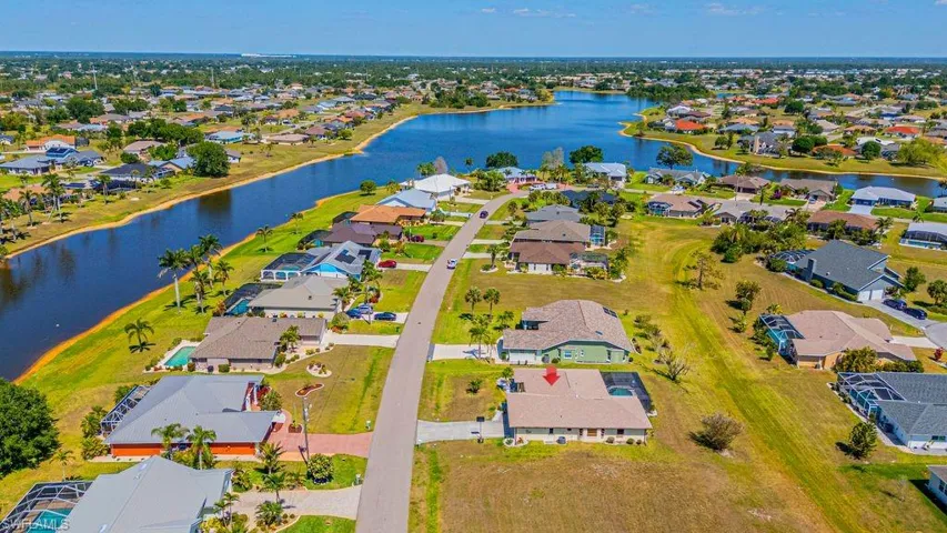 Aerial perspective of suburban area with a nearby body of water