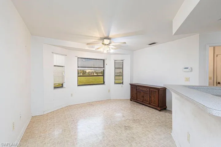 Spare room with baseboards and a ceiling fan