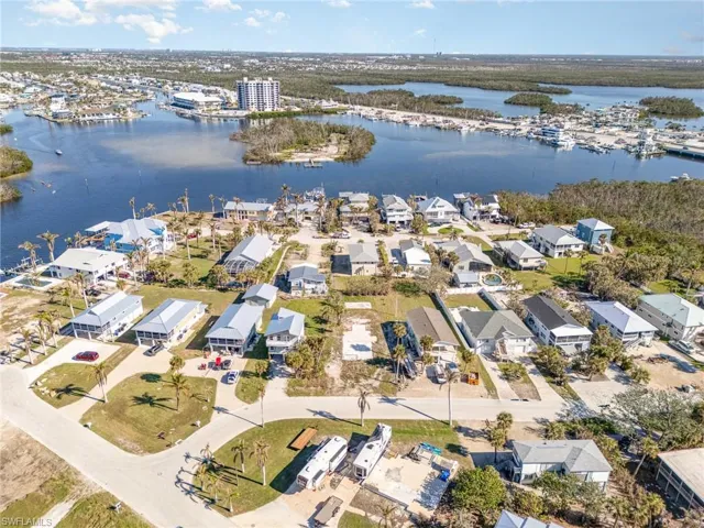 Birds eye view of property with a water view