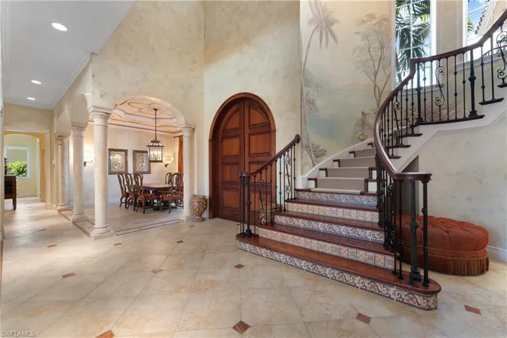 Entrance foyer with ornamental molding and a towering ceiling
