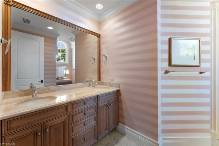 Bathroom featuring vanity and crown molding