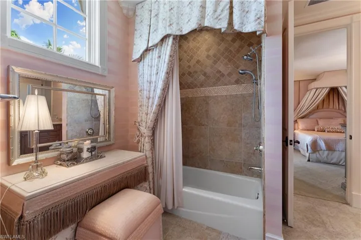 Bathroom with shower / tub combo and tile patterned flooring