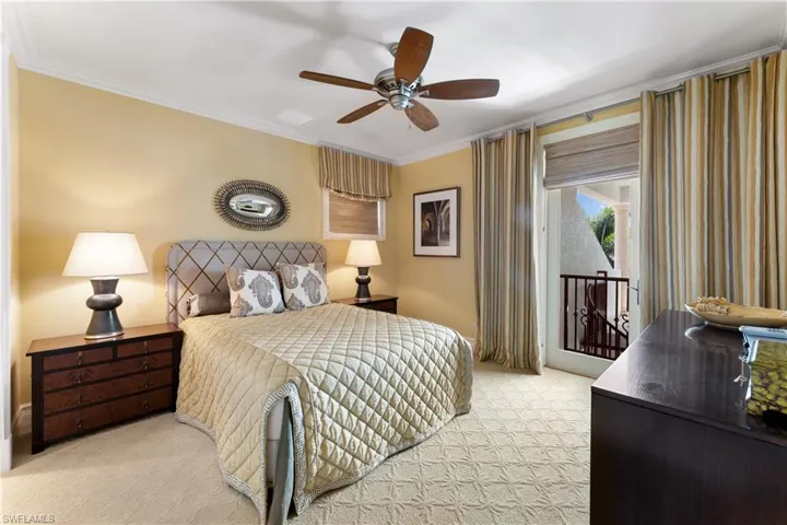 Bedroom with crown molding, light carpet, and ceiling fan