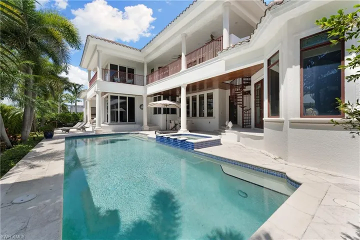 View of swimming pool with an in ground hot tub and a patio