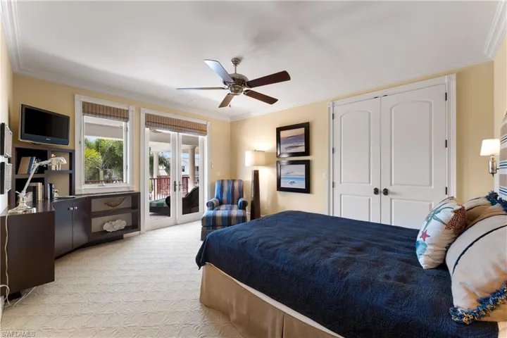 Bedroom featuring light carpet, ceiling fan, access to outside, ornamental molding, and french doors