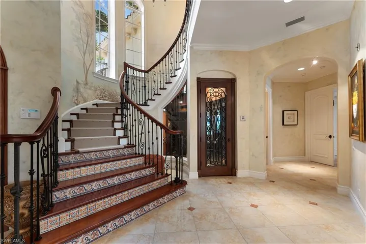 Foyer entrance featuring crown molding