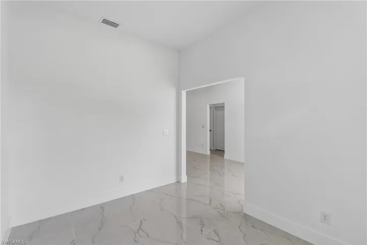 Spare room featuring baseboards