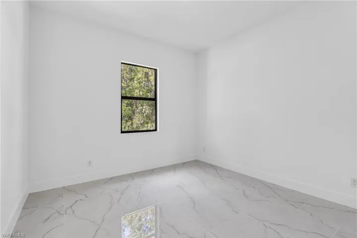 Empty room featuring baseboards and light marble finish flooring