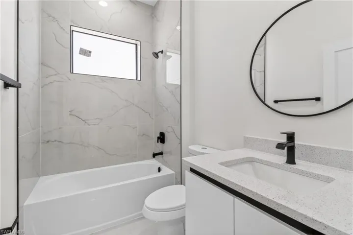 Bathroom featuring shower / bath combination and vanity