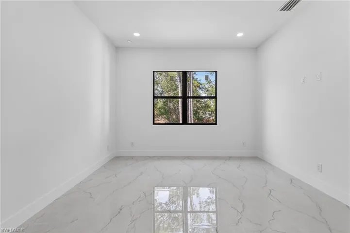 Unfurnished room featuring light marble finish flooring and recessed lighting