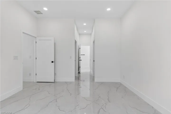 Spare room with recessed lighting and light marble finish floors