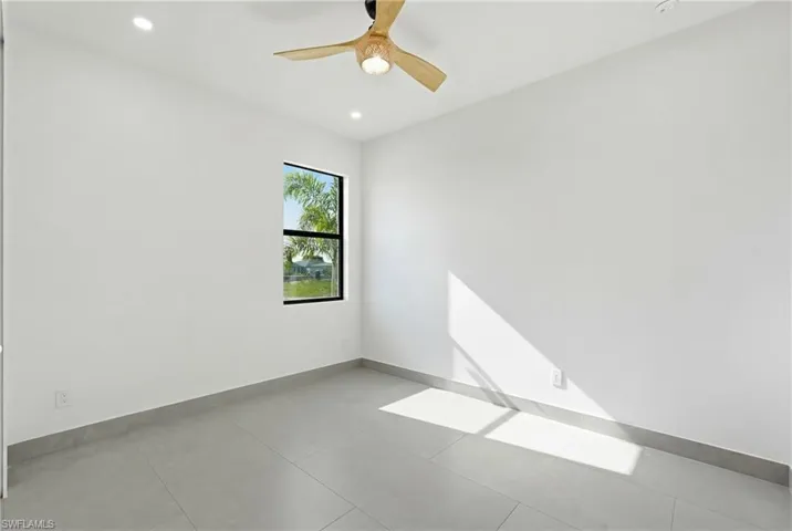 Room featuring a single window with a black frame, recessed lighting, and a wood-finish ceiling fan