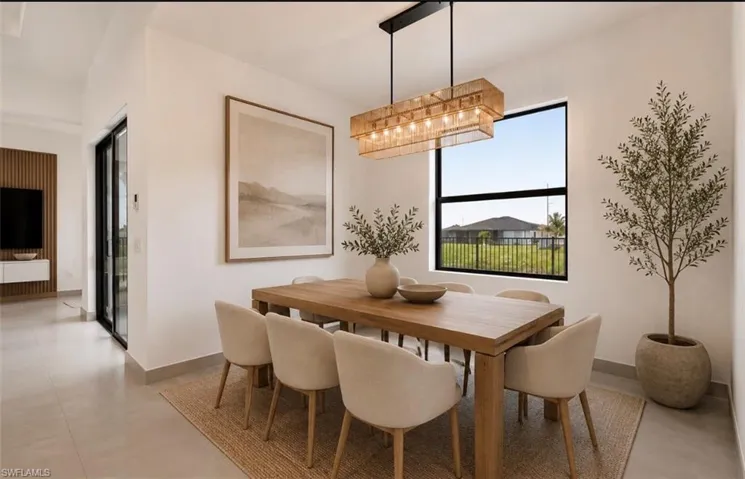 Dining area featuring a rectangular wood dining table, a linear woven chandelier, a large rectangular window, and light tile flooring