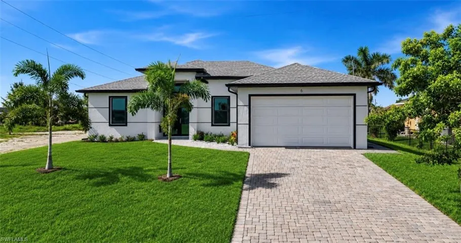 Contemporary exterior with a white stucco finish and dark trim accents
