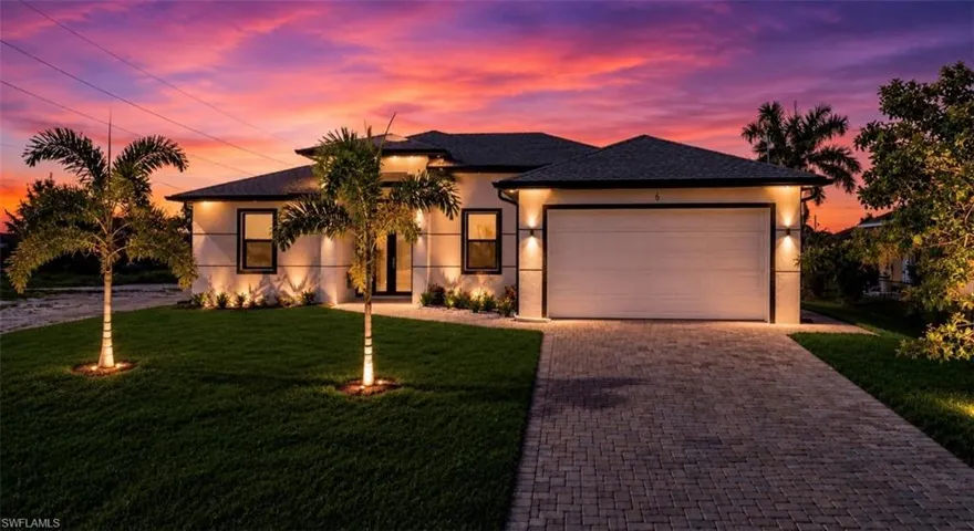 Modern exterior with a light-toned stucco finish, dark-framed windows, and a black front entry door