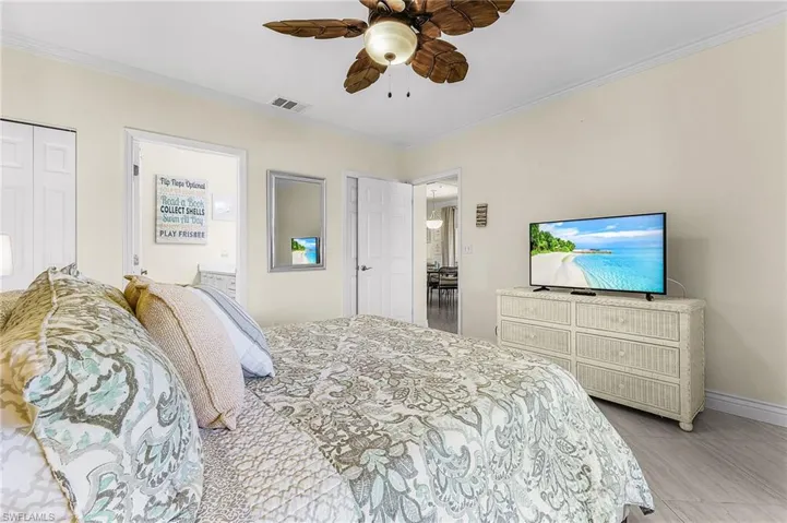 Spacious master bedroom has a walk-in closet, ensuite bathroom, and private entrance to the lanai through a set of sliding doors.