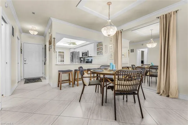 The dining area features custom mirrors that visually enlarge the area and reflect light. Bar stools allow for easy conversation between the cook and friends & family.