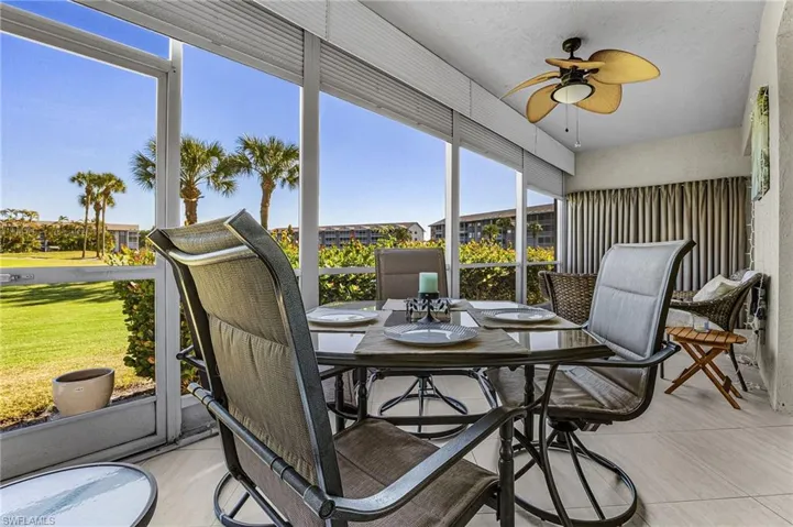 The expansive lanai is room enough for a lounging area and a dining area; it houses the laundry and storage areas behind the elegant curtains.