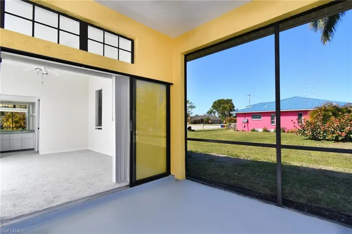 Unfurnished sunroom featuring a ceiling fan