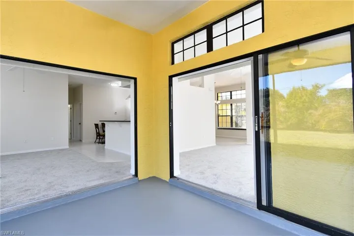 Entryway with concrete flooring and a high ceiling