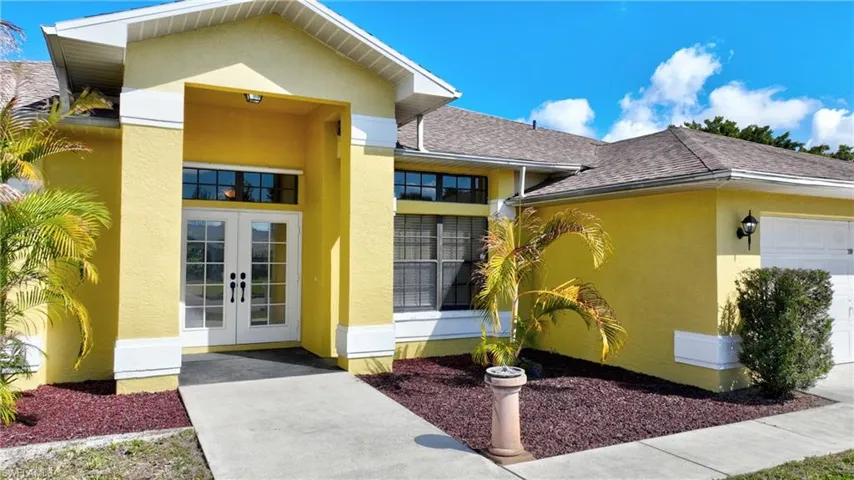 Entrance to property featuring french doors, stucco siding, a garage, and roof with shingles